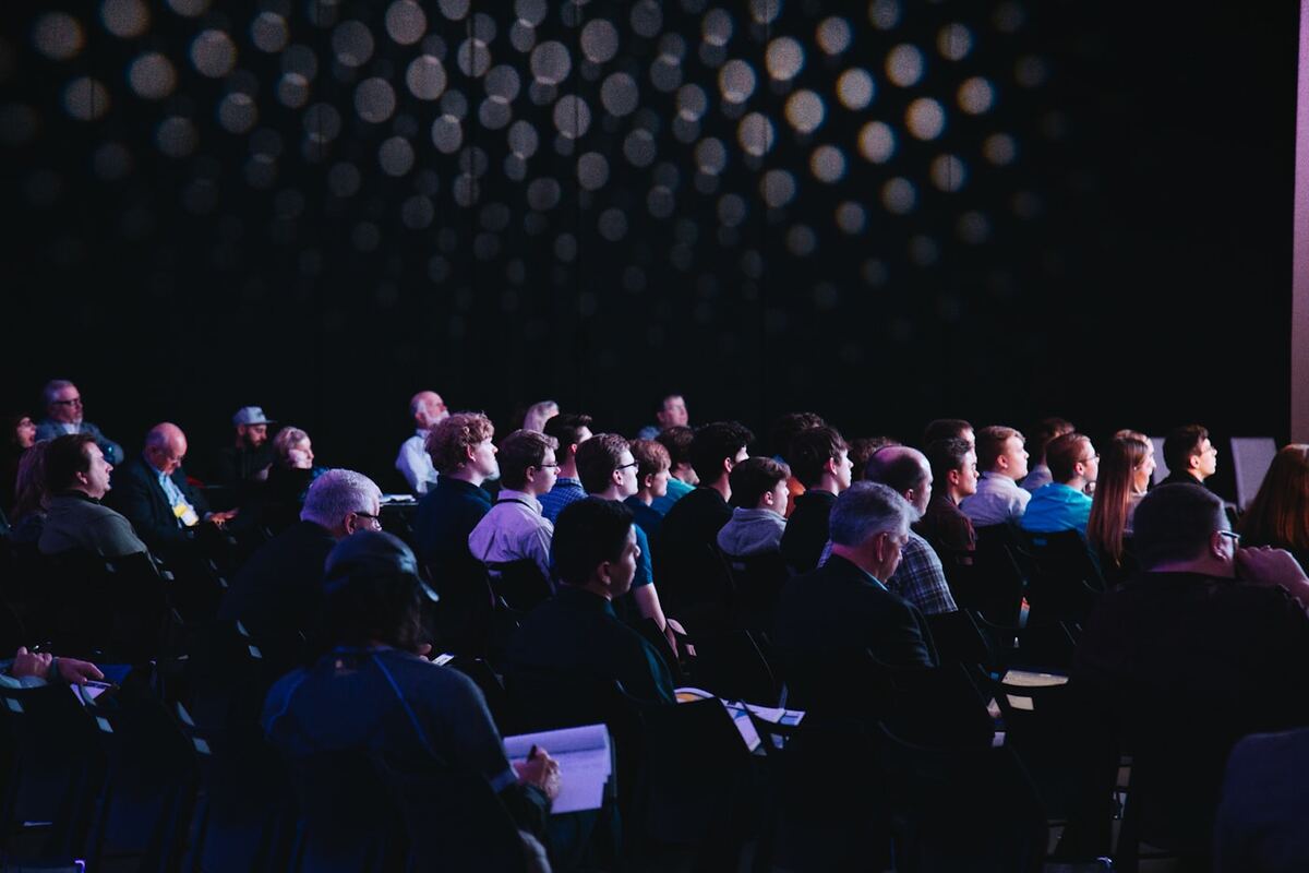 Audience seated and listening during a large presentation